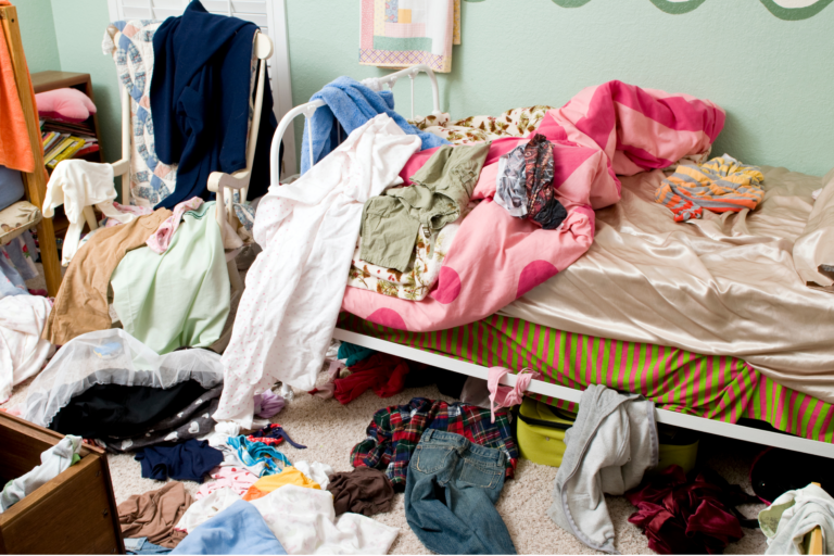 clothes have been putting all over the bed room, on the bed, chair, and floor