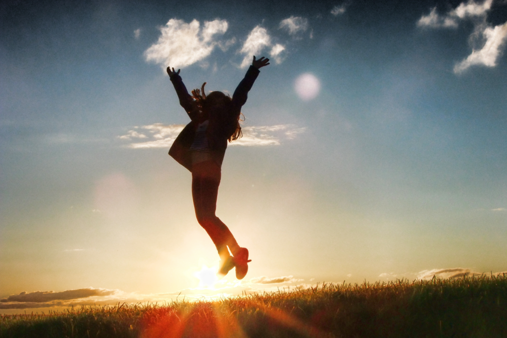woman jumps with joy