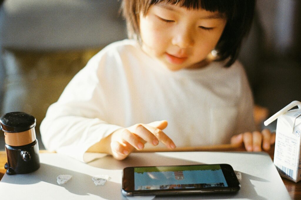 a girl playing game on smartphone